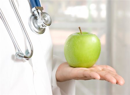 food specialist - doctor holding a green apple Photographie de stock - Aubaine LD & Abonnement, Code: 400-06358338