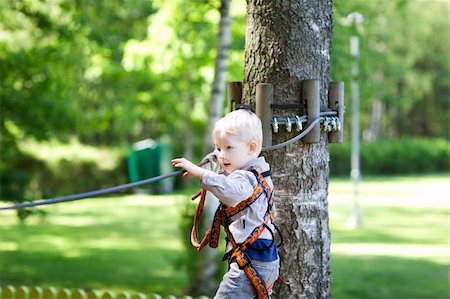 serious little boy climbing at a canopy tour Stock Photo - Budget Royalty-Free & Subscription, Code: 400-06366934