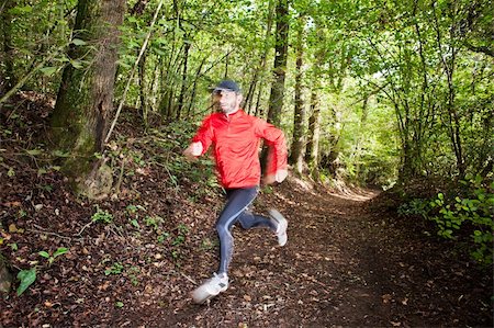 red trail - Male trail runner running in the forest on a trail. Red shirt and black pants. Summer season. Slight blur in runner to show motion. Horizontal composition. Stock Photo - Budget Royalty-Free & Subscription, Code: 400-06367310