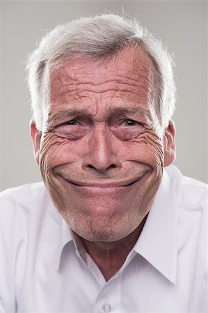 funny old people faces - Humorous portrait of a retired gray haired senior man with a wide beaming smile that epitomises the idiom, grinning from ear to ear Stock Photo - Budget Royalty-Free & Subscription, Code: 400-06361001