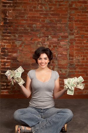 Beautiful brunette holding dollars bills Stock Photo - Budget Royalty-Free & Subscription, Code: 400-06384084