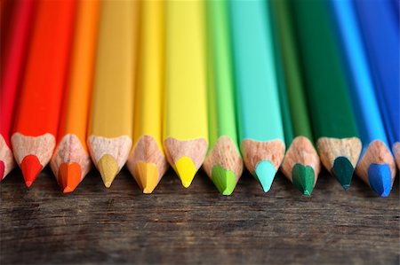 pencil crayon - Closeup of variegated crayons in a row on old wooden surface Foto de stock - Super Valor sin royalties y Suscripción, Código: 400-06388450