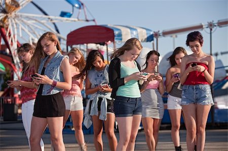 simsearch:400-04099373,k - Group of 8 teenage girls text messaging at an amusement park Stock Photo - Budget Royalty-Free & Subscription, Code: 400-06394244