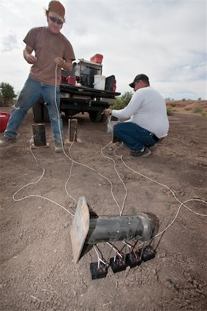 explosives - Two men in special effects team near truck setting up explosives Stock Photo - Budget Royalty-Free & Subscription, Code: 400-06396517