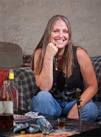 simsearch:400-06396543,k - Smiling middle aged woman in leather with dagger and alcohol Stock Photo - Budget Royalty-Free & Subscription, Code: 400-06396548