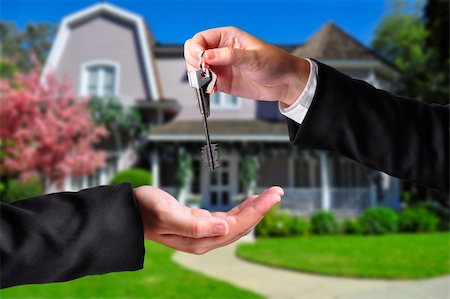 simsearch:400-04852236,k - A hand giving a key to another hand. Both persons in suits and a house in the background. Stock Photo - Budget Royalty-Free & Subscription, Code: 400-06391668