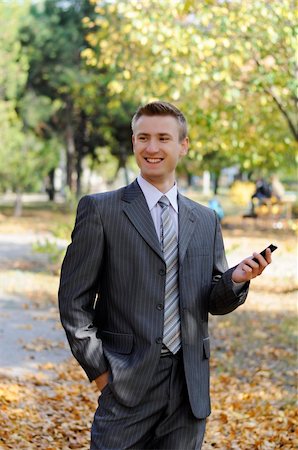 simsearch:859-06710917,k - businessman looks on the phone  in the autumn park Stock Photo - Budget Royalty-Free & Subscription, Code: 400-06393711