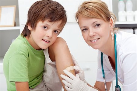 Putting a bandaid on wound - boy in emergency room Stock Photo - Budget Royalty-Free & Subscription, Code: 400-06408418