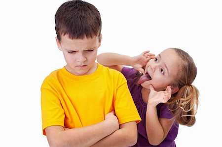 Young girl mocking angry boy - isolated Stock Photo - Budget Royalty-Free & Subscription, Code: 400-06408439