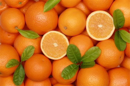 Collection of fresh oranges with leaves forming a background Stock Photo - Budget Royalty-Free & Subscription, Code: 400-06415743