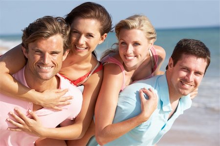 friends piggyback beach - Group Of Friends Enjoying Beach Holiday Stock Photo - Budget Royalty-Free & Subscription, Code: 400-06418465