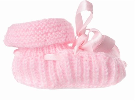 One pink baby bootee with a bow, isolated on a white background Stock Photo - Budget Royalty-Free & Subscription, Code: 400-06413442