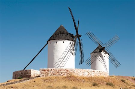 simsearch:400-05319608,k - White ancient windmills. Blue sky background Stock Photo - Budget Royalty-Free & Subscription, Code: 400-06424919