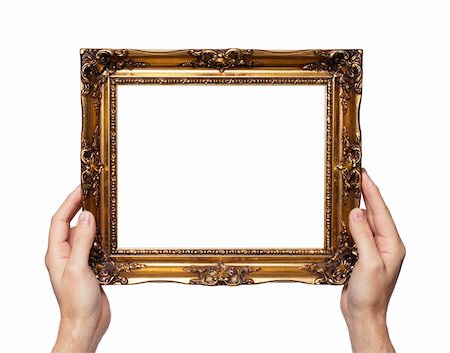 Man holding antique style golden color picture frame in his hands. Stock Photo - Budget Royalty-Free & Subscription, Code: 400-06428944