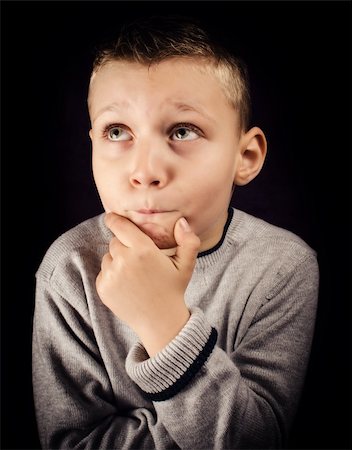 simsearch:400-05388090,k - Boy with hand on chin and looking up trying to solve a problem Stock Photo - Budget Royalty-Free & Subscription, Code: 400-06429707