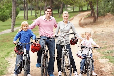 simsearch:400-06412547,k - Family enjoying bike ride in park Stock Photo - Budget Royalty-Free & Subscription, Code: 400-06420411