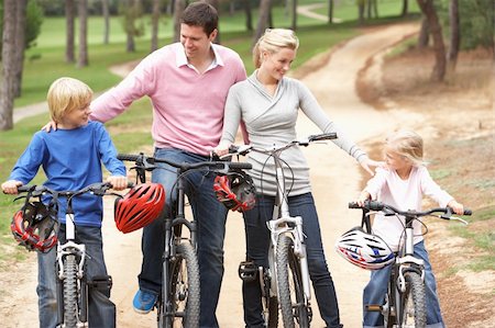 simsearch:400-06412547,k - Family enjoying bike ride in park Stock Photo - Budget Royalty-Free & Subscription, Code: 400-06420412