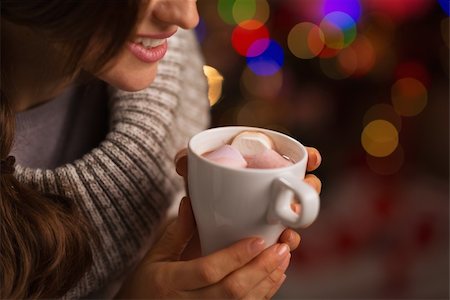 Closeup on hot chocolate with marshmallows in hand of happy woman Stock Photo - Budget Royalty-Free & Subscription, Code: 400-06458845