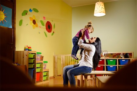 People having fun at school, female educator lifting mid-air child in kindergarten Stock Photo - Budget Royalty-Free & Subscription, Code: 400-06459858