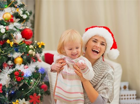 Portrait of happy mother and baby near Christmas tree Stock Photo - Budget Royalty-Free & Subscription, Code: 400-06464751
