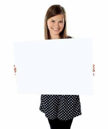 Smiling young girl showing blank placard to camera Stock Photo - Budget Royalty-Free & Subscription, Code: 400-06484144