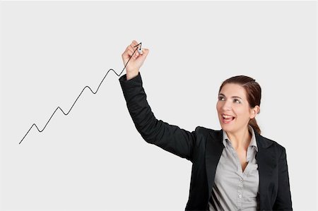 Beautiful woman drawing a chart with a recent ascent of the company Stock Photo - Budget Royalty-Free & Subscription, Code: 400-06485115