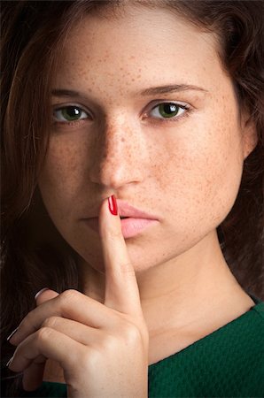 simsearch:400-04175955,k - Closeup of a woman with her finger over her mouth Stock Photo - Budget Royalty-Free & Subscription, Code: 400-06480010