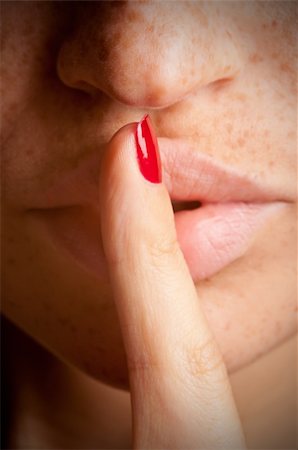 simsearch:400-04175955,k - Closeup of a woman with her finger over her mouth Stock Photo - Budget Royalty-Free & Subscription, Code: 400-06480011