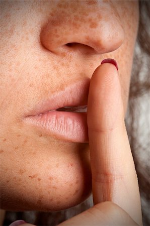 simsearch:400-04175955,k - Closeup of a woman with her finger over her mouth Stock Photo - Budget Royalty-Free & Subscription, Code: 400-06480012