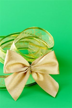 gold bow and ribbon  on a green background Stock Photo - Budget Royalty-Free & Subscription, Code: 400-06481295