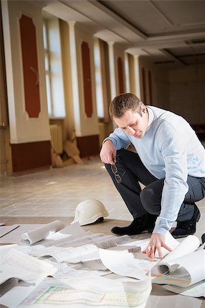 Architect looking blueprint on the floor of the reconstruction interior. Stock Photo - Budget Royalty-Free & Subscription, Code: 400-06526881