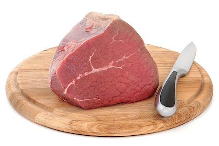 Silverside of beef meat joint on a carving board with knife over white background. Stock Photo - Budget Royalty-Free & Subscription, Code: 400-06527881