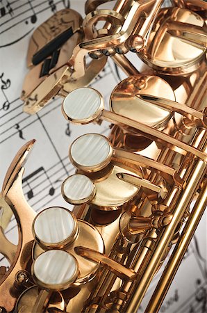 simsearch:400-04863651,k - Alto Saxophone main, palm left hand keys & spatula / table keys closeup with score notes in background Stock Photo - Budget Royalty-Free & Subscription, Code: 400-06566850