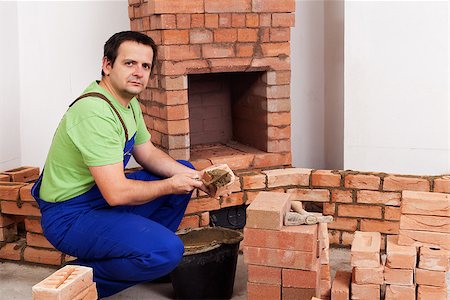 Masonry worker building rustic traditional fireplace Stock Photo - Budget Royalty-Free & Subscription, Code: 400-06569051