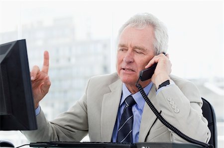 simsearch:400-05710264,k - Focused senior manager on the phone in his office Stock Photo - Budget Royalty-Free & Subscription, Code: 400-06627063