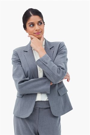 executive standing white background - Thinking businesswoman looking to the side against a white background Photographie de stock - Aubaine LD & Abonnement, Code: 400-06627235