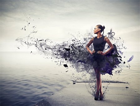 simsearch:400-06628918,k - Elegant black girl with a black dress with black paint standing on a pier Photographie de stock - Aubaine LD & Abonnement, Code: 400-06628918