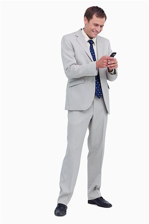 simsearch:400-06632132,k - Smiling businessman reading text message against a white background Stock Photo - Budget Royalty-Free & Subscription, Code: 400-06634714