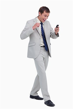 simsearch:400-06632132,k - Happy businessman getting good news via text message against a white background Stock Photo - Budget Royalty-Free & Subscription, Code: 400-06634716