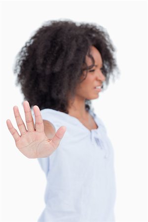 Side view of an angry woman making the hand stop sign against a white background Stock Photo - Budget Royalty-Free & Subscription, Code: 400-06635076