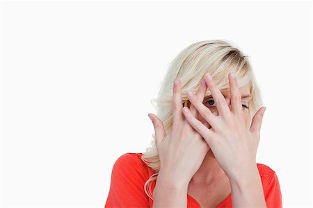 Blonde woman hiding her face behind her hands against a white background Stock Photo - Budget Royalty-Free & Subscription, Code: 400-06635278