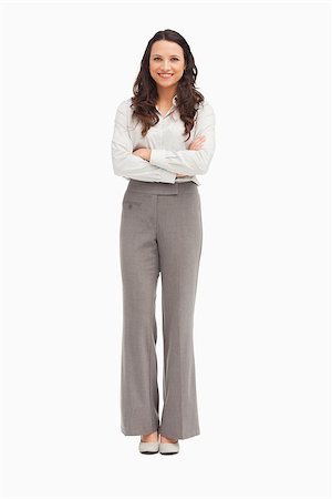 executive standing white background - Pretty employee with folded arms against white background Photographie de stock - Aubaine LD & Abonnement, Code: 400-06636547