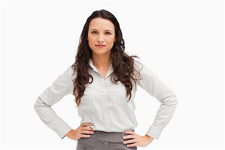 executive standing white background - Portrait of a brunette businesswoman hands on hips against a white background Photographie de stock - Aubaine LD & Abonnement, Code: 400-06636585