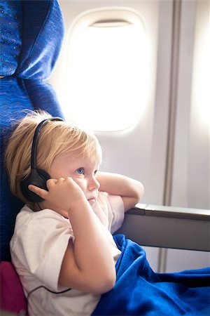 small child with headphones in the plane Stock Photo - Budget Royalty-Free & Subscription, Code: 400-06638628