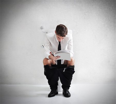 Young man reading a magazine on the toilet Stock Photo - Budget Royalty-Free & Subscription, Code: 400-06639903