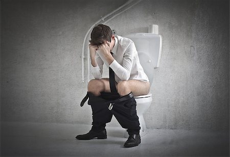 Young office worker sitting on a toilet Stock Photo - Budget Royalty-Free & Subscription, Code: 400-06639945