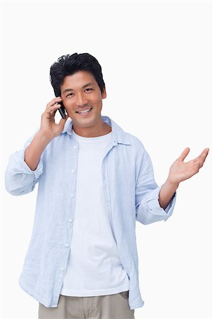simsearch:400-06632132,k - Smiling male talking on the cellphone against a white background Stock Photo - Budget Royalty-Free & Subscription, Code: 400-06632286