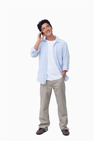 simsearch:400-06632132,k - Smiling male on his cellphone against a white background Stock Photo - Budget Royalty-Free & Subscription, Code: 400-06632280