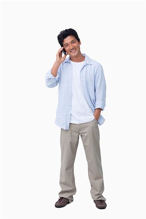 simsearch:400-06632132,k - Smiling male on cellphone against a white background Stock Photo - Budget Royalty-Free & Subscription, Code: 400-06632281