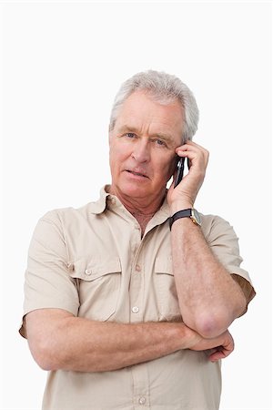 simsearch:400-06632132,k - Mature man with his cellphone against a white background Stock Photo - Budget Royalty-Free & Subscription, Code: 400-06632305